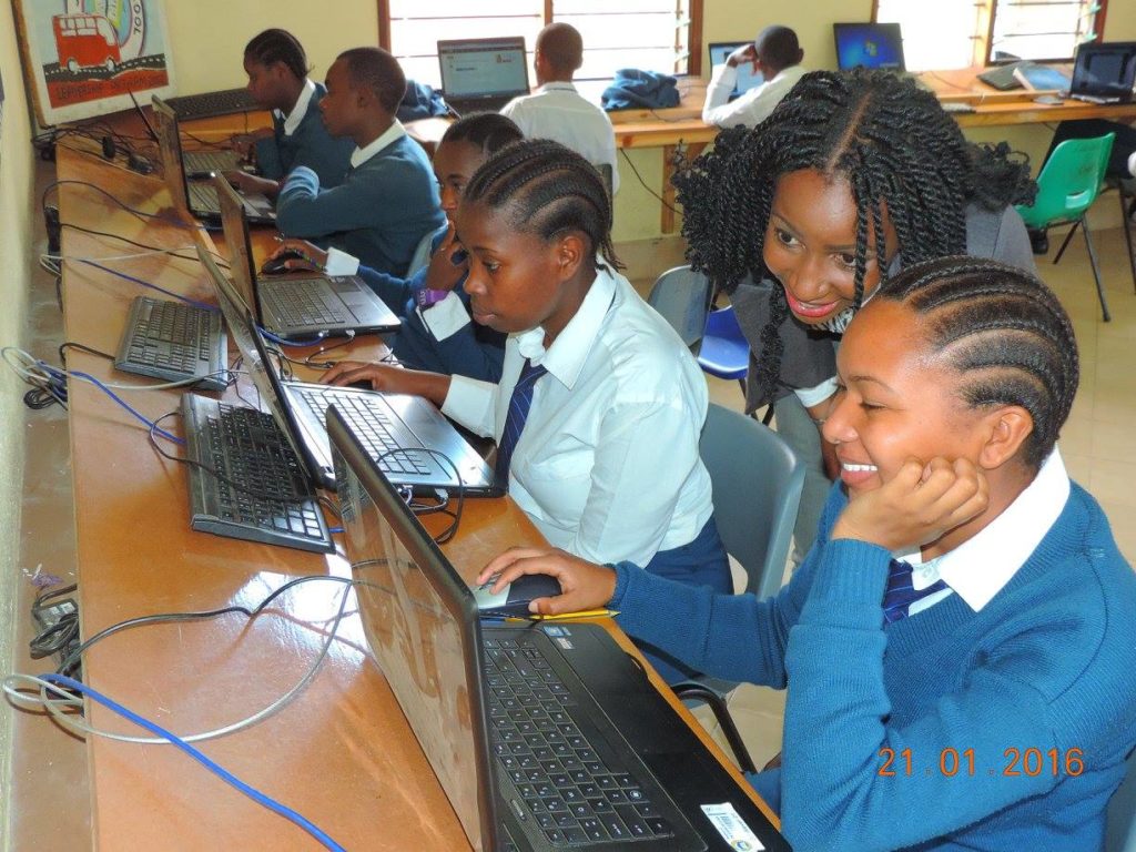 Faraja Nyalandu assists a school girl using Shule Direct platform