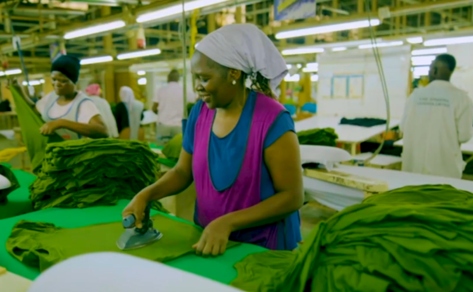 A worker ironing garments at Fine Spinners’ Kampala textile mill